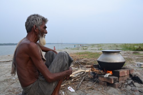 Mannaf tends to the food for the group, in midst of the majestic Padma river.