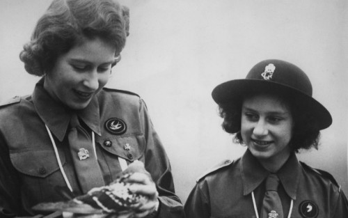 Queen Elizabeth II seen with a racing pigeon in her hands in her early days.