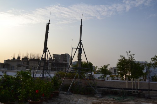 Cell towers on a rooftop of a residential apartment building in the city.