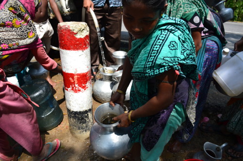 Pitchers of different shapes and sizes being filled up with potable water