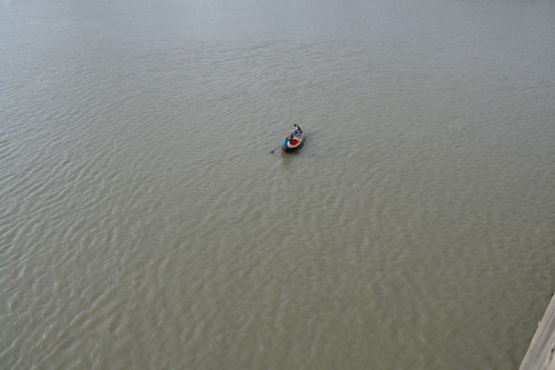 A solitary boatman still plying the Buriganga on a traditional boat.