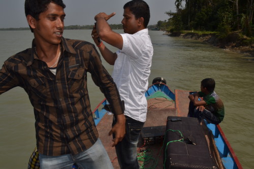 The wedding party dances their way on a traditional boat.