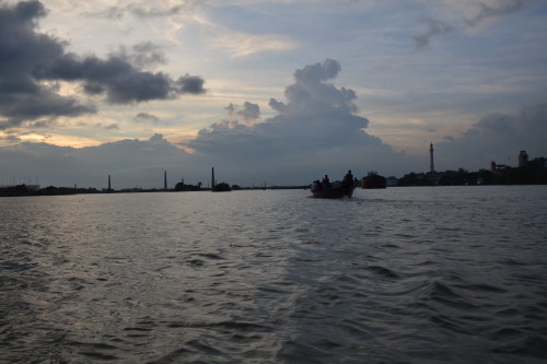 Boats of different shapes and sizes still ply the Buriganga, set in the backdrop are the new modes of making a living, the brick-kilns.