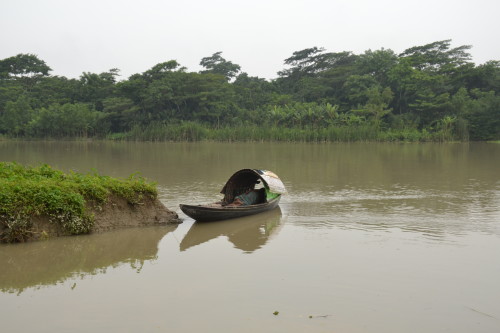 A boatman enjoys an afternoon nap in the serene settings of the backwaters in the southern regions of Bangladesh.