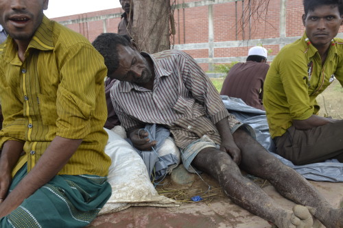 An exhausted cowboy (cattle herder) from Sherpur, dozes off in the shade just next to a cattle market in the city.