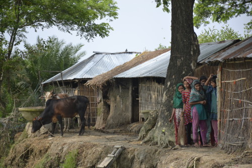 A group of villagers look on anxiously in Gandamara, Banshkhali.