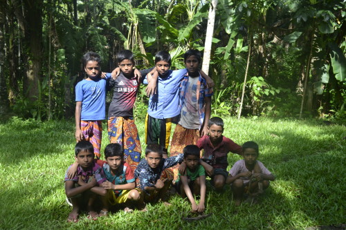 Children gather near an betel nut orchard.